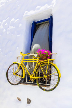 Charming street decoration with old bike in the wall, Greece