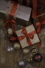 Christmas presents and baubles on a wooden background
