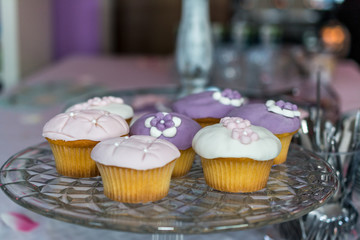 Pink and purple cupcakes on a tray ready to serve on a wedding