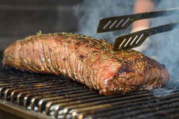 Large entrecote on a barbecue prepared by a chef