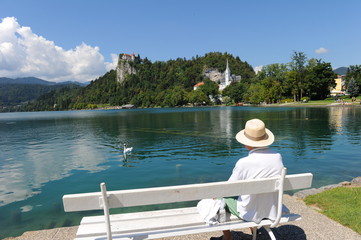 Fototapeta na wymiar Old man enjoying the Bled Lake scenery, Slovenia