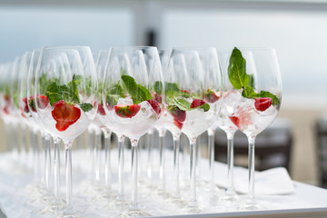 Cocktail glasses with strawberries and ice at a ceremonie