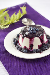 Sweet pudding with blueberry confiture