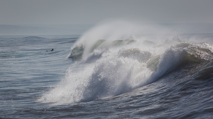 Ocean waves in Costa da Caparica. Autumn day in Almada, Portugal.
