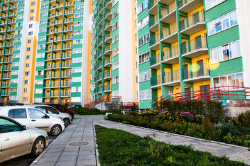 Urban courtyard, a tall building and cars