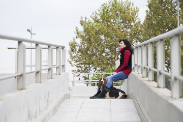 A young woman sits with a dog