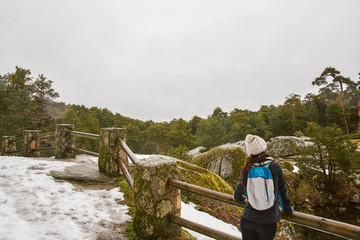 Fototapeta na wymiar Hiking - woman hiker enjoying the scenery in the snowy forest. L