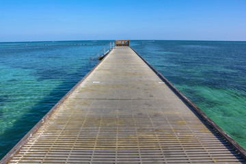 Infinity walkway pier. Wooden pier in Higgs Beach, a popular Key West beach in Florida. Infinity and freedom concept.