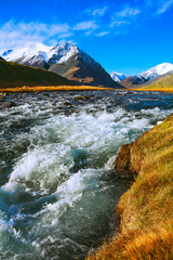autumn landscape mountain river with rapid current of water flow