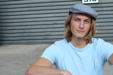 Portrait of a smiling Caucasian man in newsboy hat looking to camera with copy space