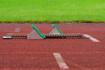 Athletics Starting Blocks on a red running track