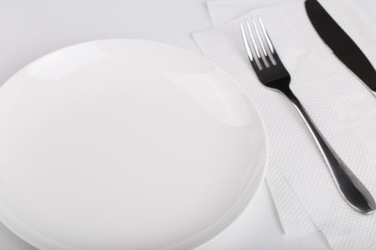 Plate knife and fork on the white