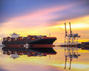 Fototapeta premium Container Cargo freight ship with working crane bridge in shipyard at dusk for Logistic Import Export background