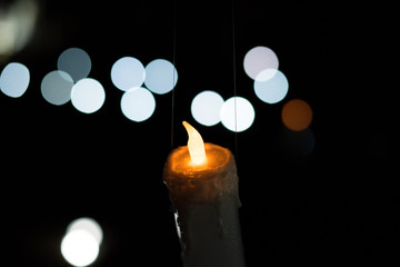 The flame of the candle and black scenery