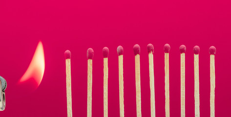 Burning matchsticks setting fire to its neighbors