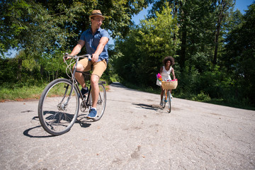 Fototapeta premium Young multiethnic couple having a bike ride in nature