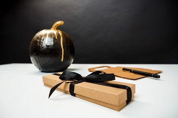 Halloween decor on white table over black background.
