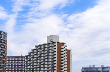 Fototapeta na wymiar Real estate image, tower apartment building against blue sky