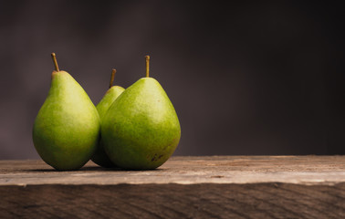 Three pears on wood with space for text