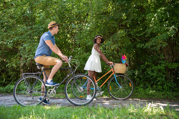 Young multiethnic couple having a bike ride in nature