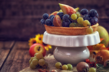 Autumn concept - Autumn fresh fruit on wooden background with copy space 
