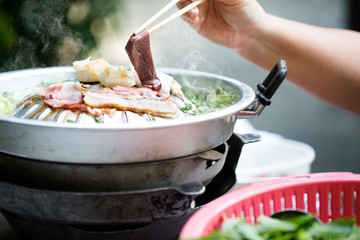 Grilling sliced pork and meat on hot pan asian style / selectiv