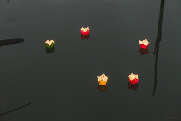 Handmade paper lanterns floating in the water of a Thu Bon river  of Hoi An, Vietnam. Dusk light