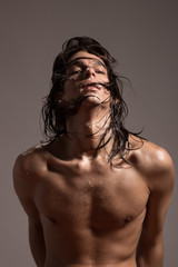 Fashion photography nude body young man model wet long hair