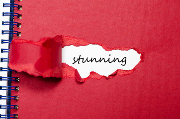 The word stunning appearing behind torn paper