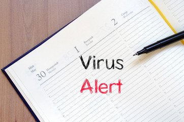 Virus alert text concept on notebook