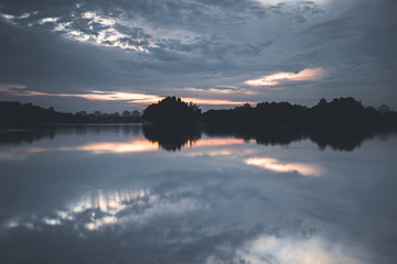 Reflection of clouds during sunset. Shot at the lake in a recreational park