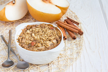 Baked oatmeal with nuts, almond milk, spices and asian pear