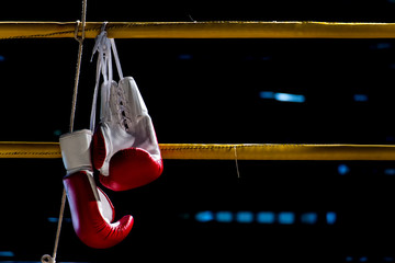 boxing gloves hangs off the boxing ring in a slum camp