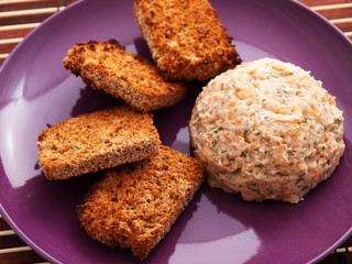Humus with baked bread slices in a purple plate. Horizontal shot