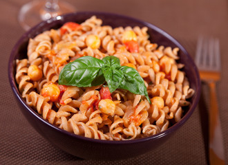 Italian fusilli pasta with chick-peas, close up, decorated with