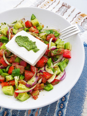 Salad with tomatoes, peppers, onion, feta cheese and pesto
