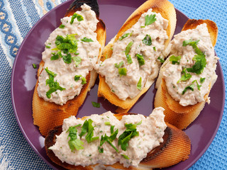 Italian bruschetta sandwiches with tuna pate, topped with parsle
