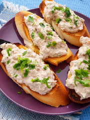 Italian bruschetta sandwiches with tuna pate, topped with parsle