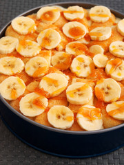 Homemade cake with bananas and caramel in a bowl