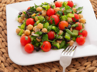 Salad with tomatoes, cucumbers and chickpeas. Horizontal shot