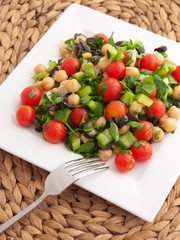 Salad with tomatoes, cucumbers and chickpeas. Vertical shot