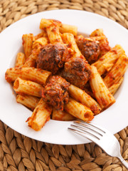 Itailian penne pasta with meatballs and tomatoes sauce