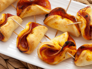 Baked small pizza rolls with ham and cheese. Horizontal shot
