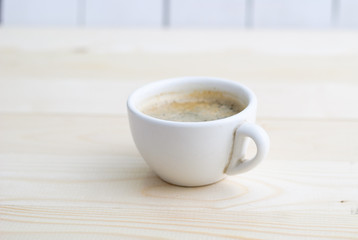 Cup of coffee on wooden table