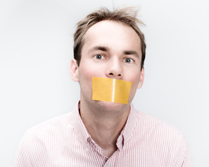 Tied man with taped mouth as a hostage in studio