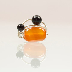 Silver jewels with colorful precious stones and light grey background