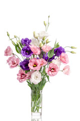 bunch of violet, white and pink eustoma flowers in glass vase is