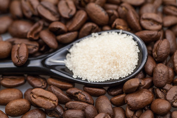 Coffee beans, brown sugar and small teaspoons