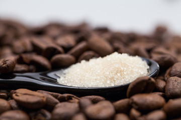 Coffee beans, brown sugar and small teaspoons