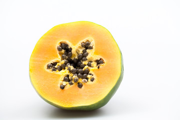 Papaya fruit - half and slice with seeds and light grey background